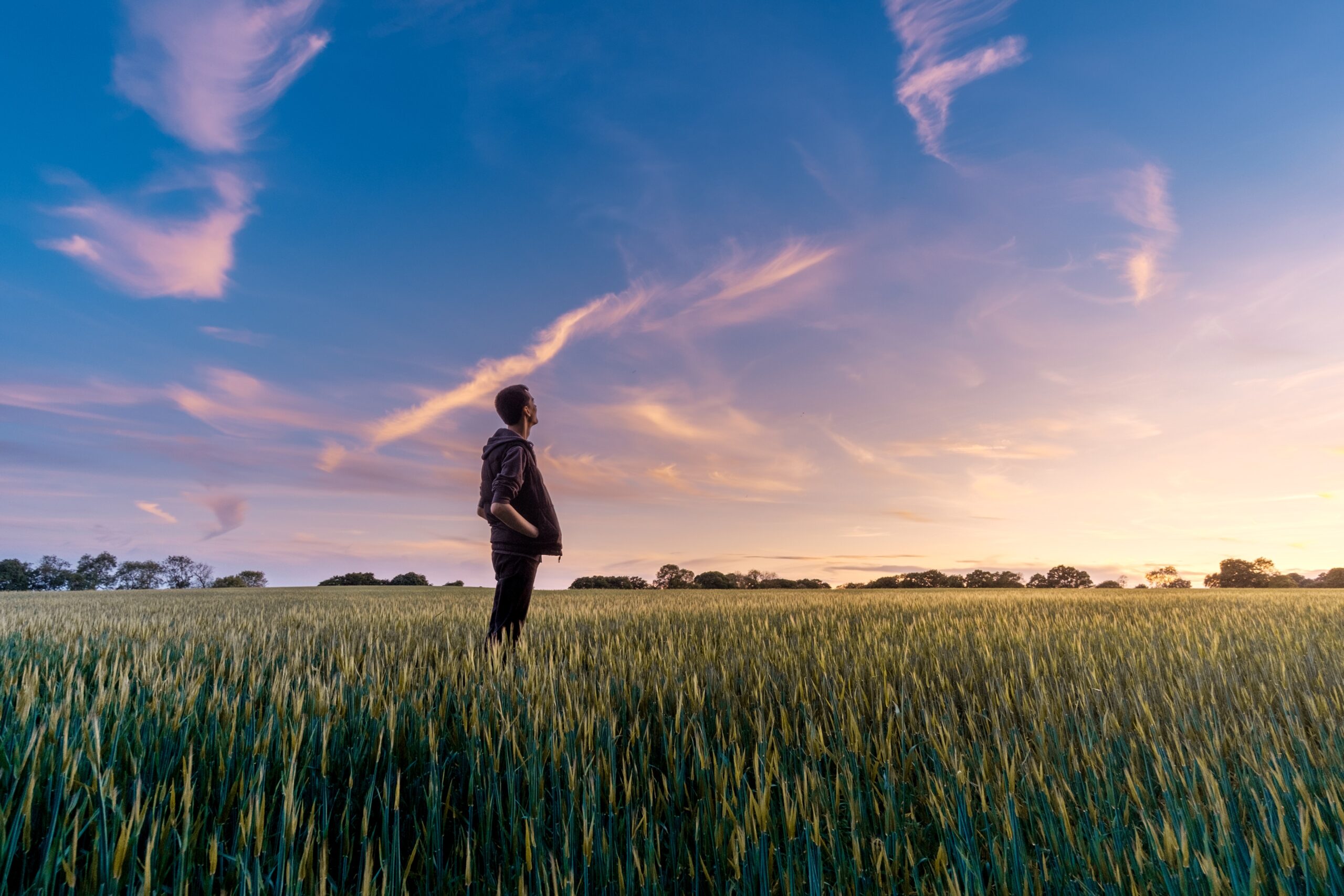 Looking at the sky thinking in a field